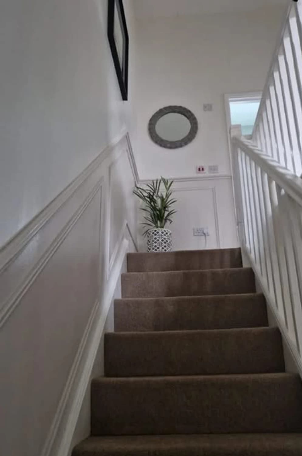 Classic wall panelling running the full height of a staircase