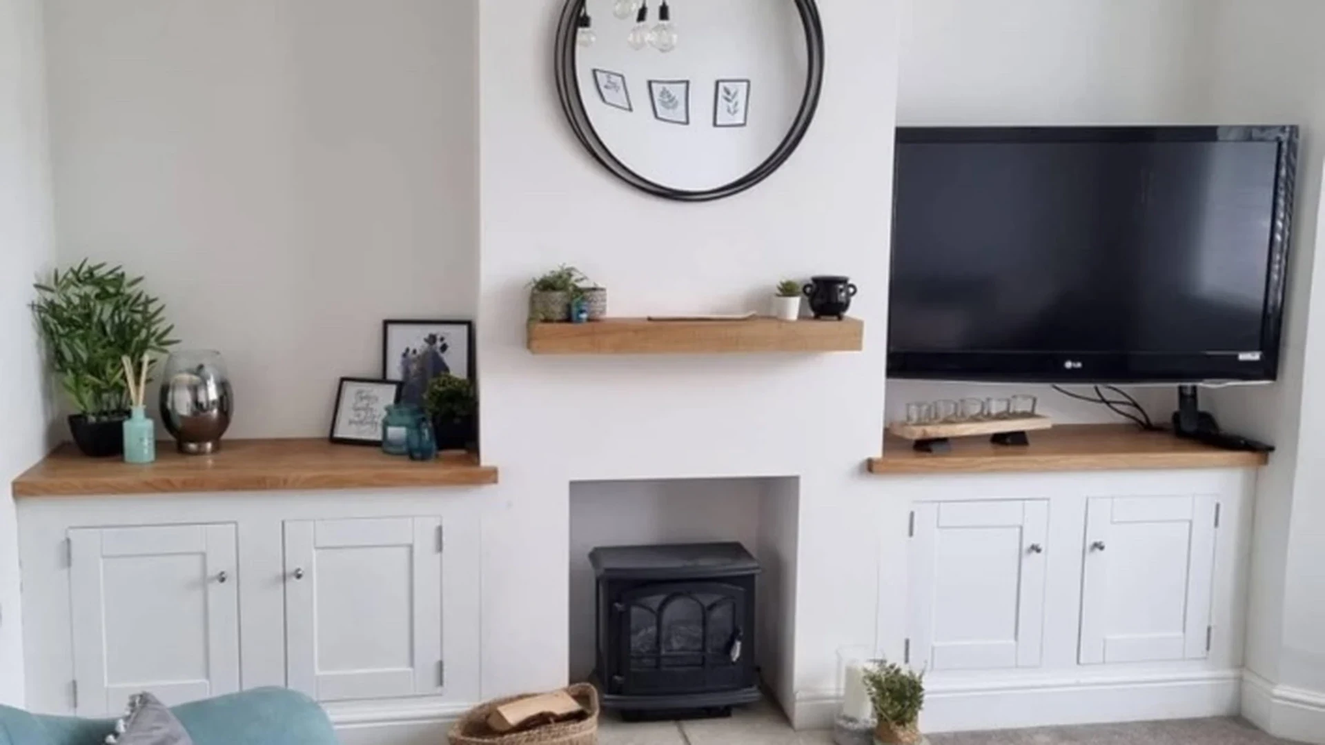 Bespoke alcove cabinetry with oak tops, built around a fireplace in a Swindon living room